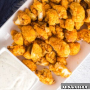 Spicy Air Fryer Cauliflower Wings 10 Plate of air fryer buffalo cauliflower with a side of dipping sauce.