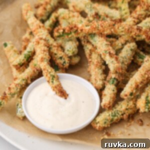Air Fryer Crispy Green Bean Sticks 9 A serving of crispy Air Fryer Green Bean Fries with a dipping sauce, ready to be enjoyed.