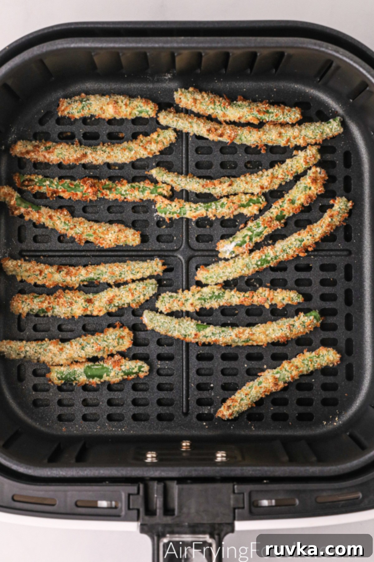 Air Fryer Crispy Green Bean Sticks 6 A batch of perfectly crispy, golden-brown Air Fryer Green Bean Fries inside the air fryer basket, ready to be served.