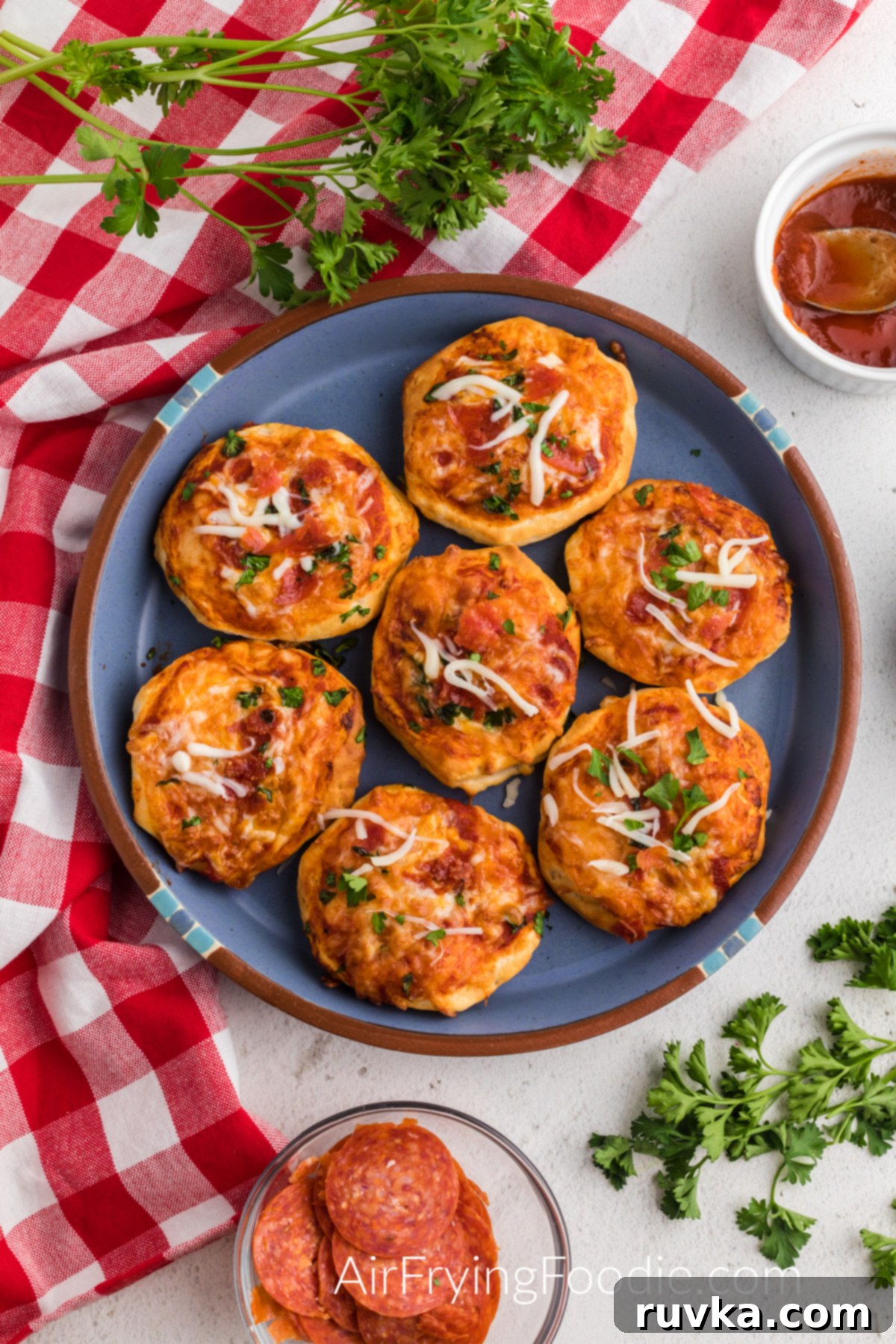 Crispy Air Fryer Pizza Bites 19 Air Fried Mini Pizzas on a blue plate ready to serve.