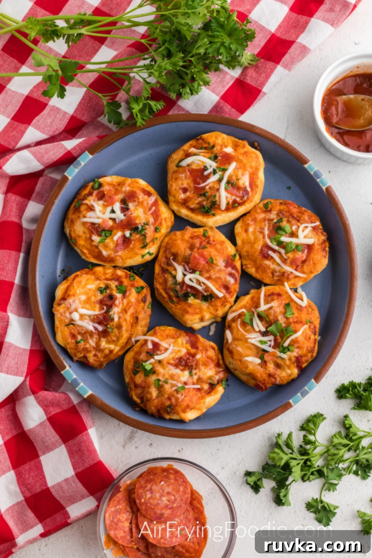 Crispy Air Fryer Pizza Bites 7 mini pizzas made in the air fryer and served on a blue plate.
