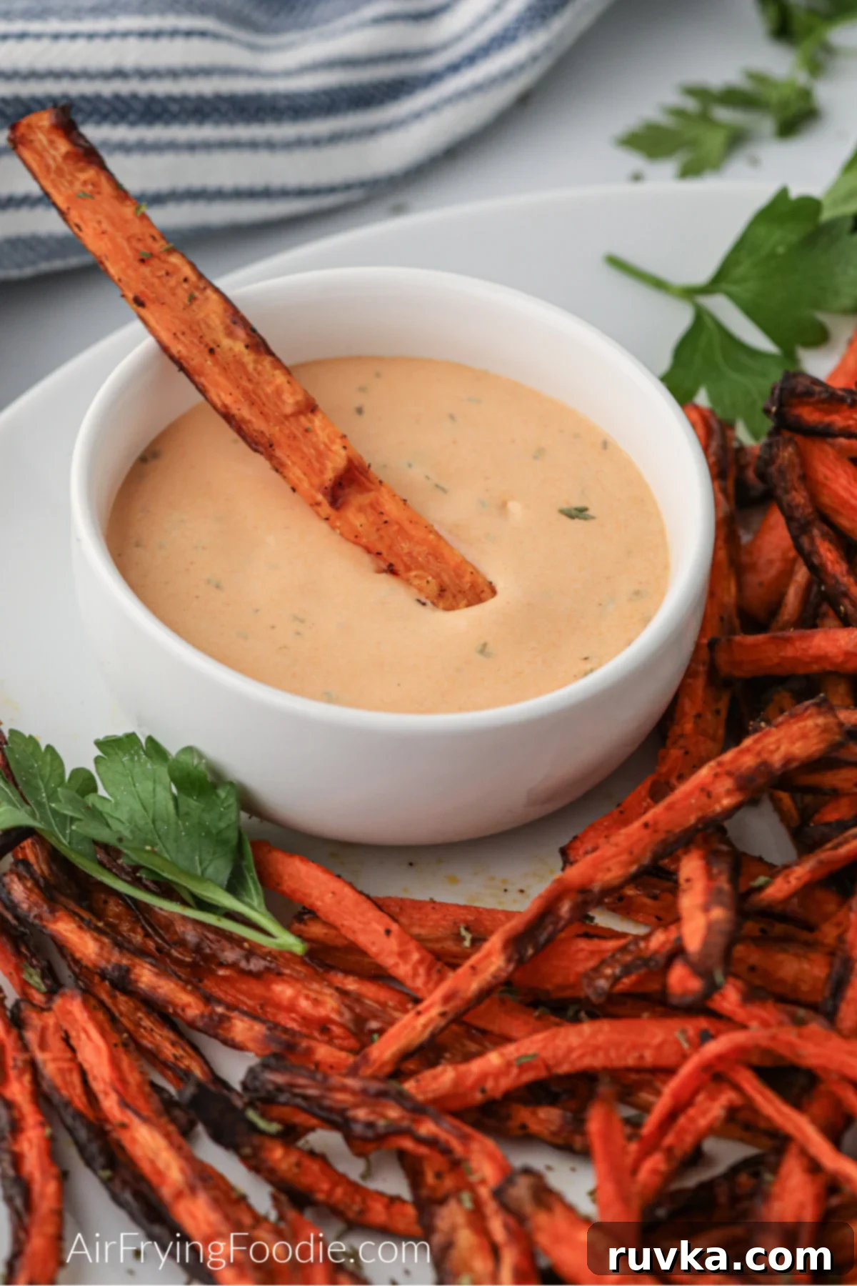 Crispy Air Fryer Carrot Fries 2 Crispy air fryer carrot fries on a plate and in dipping sauce.