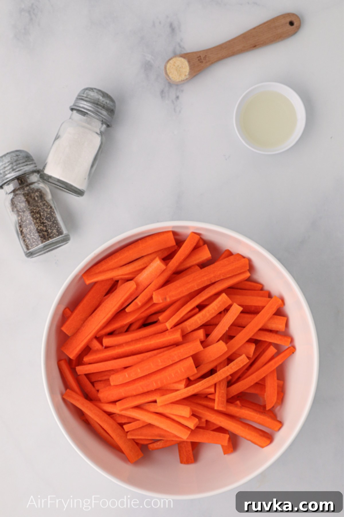 Crispy Air Fryer Carrot Fries 4 Carrots cut lengthwise ready to be seasoned before being air fried.