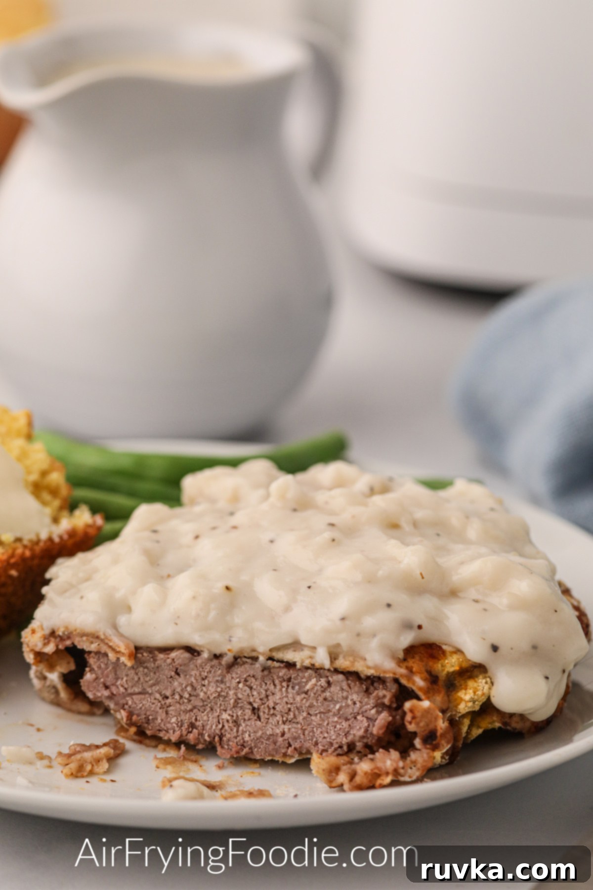 Crispy Air Fryer Chicken Fried Steak 9 Delicious air fryer chicken fried steak covered with white gravy and ready to eat.
