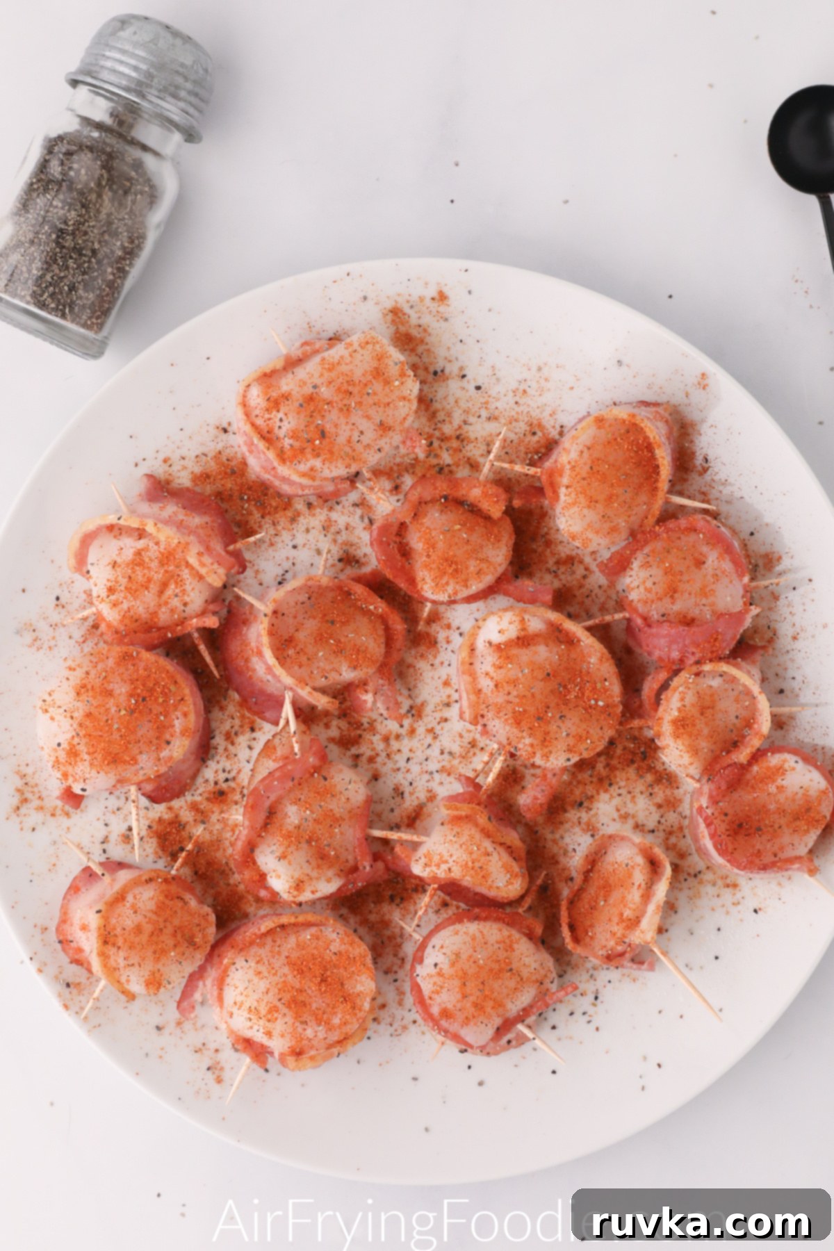 Crispy Air Fryer Bacon Wrapped Scallops 4 Scallops wrapped in bacon ready for the air fryer.