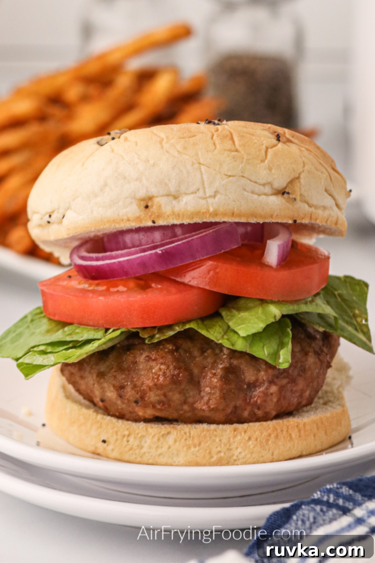 Crispy Air Fryer Turkey Burgers 2 Air Fryer Turkey Burger on a white plate ready to eat.