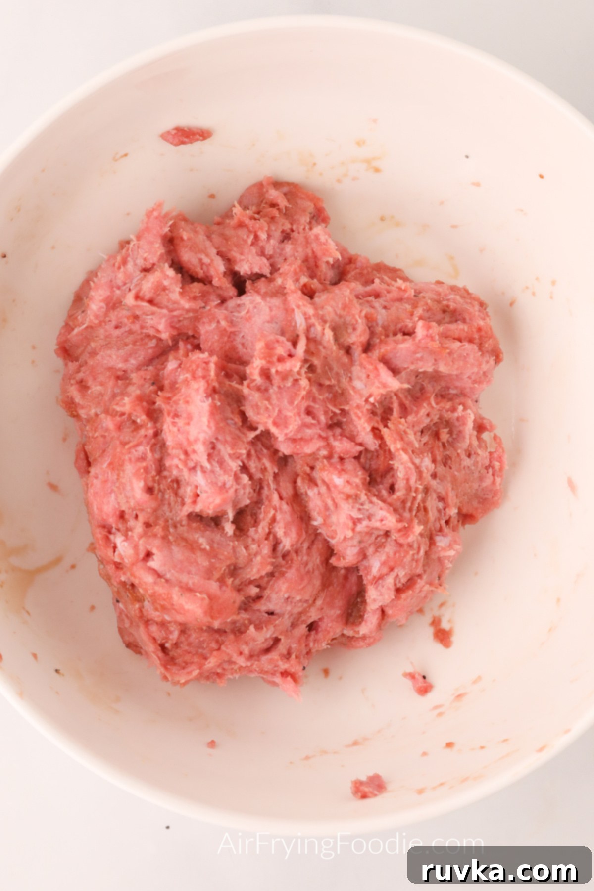 Crispy Air Fryer Turkey Burgers 4 Ground turkey meat and seasonings mixed in a bowl.
