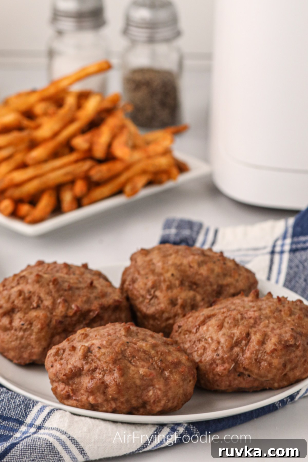 Crispy Air Fryer Turkey Burgers 8 Turkey burgers on a plate ready to dress and serve.