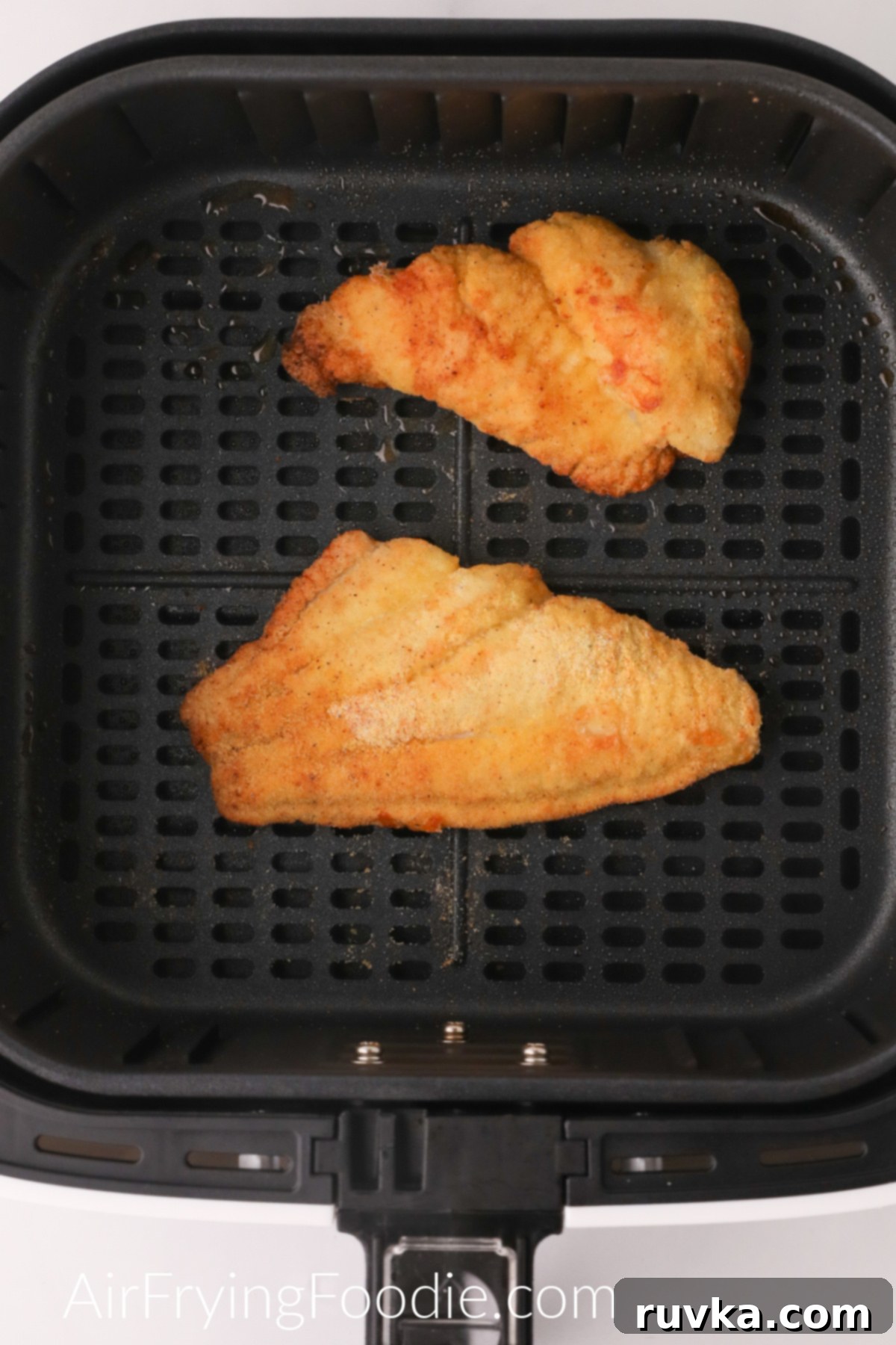 Perfectly Crispy Air Fryer Catfish 6 Air fried catfish in the basket of the air fryer, ready to serve.