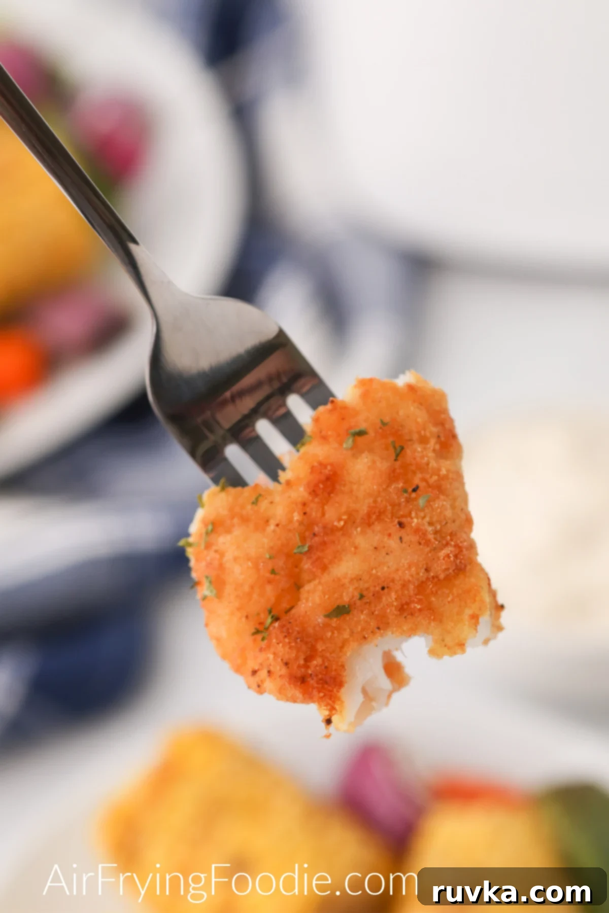 Perfectly Crispy Air Fryer Catfish 8 Bite of air fryer catfish on a fork ready to eat.