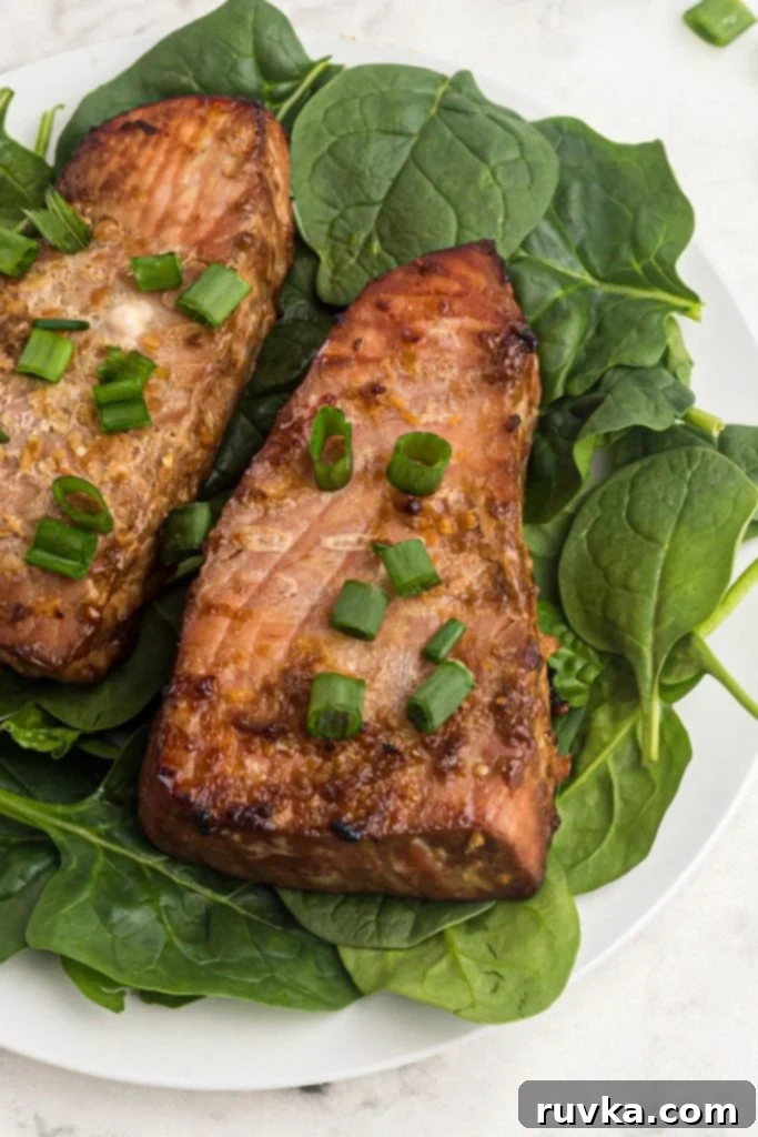 Crispy Air Fryer Tuna Steaks 2 Juicy tuna steaks seasoned and cooked on a bed of spinach. Garnished with green onions