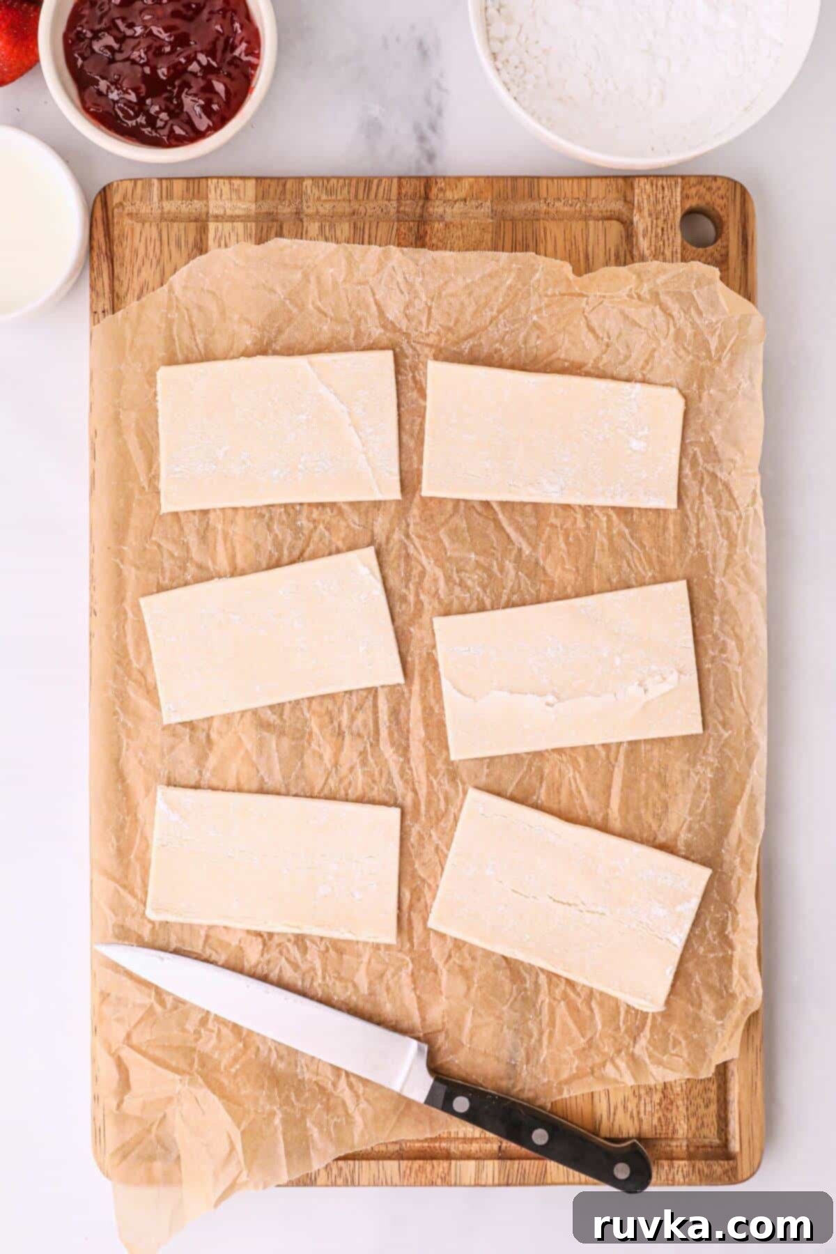 Air Fried Pop Tart Perfection 4 Pastry sheet cut into rectangles on a cutting board.
