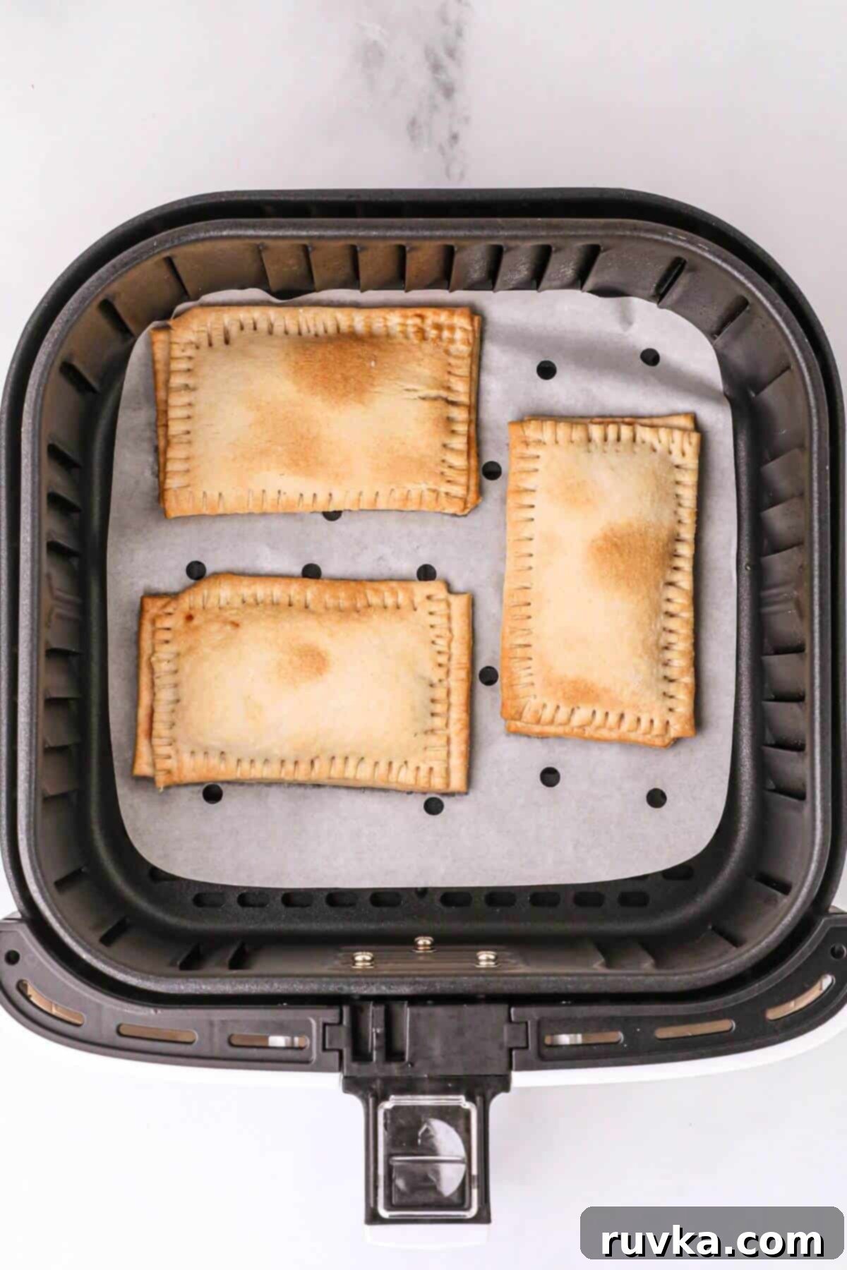 Air Fried Pop Tart Perfection 8 Golden brown cooked pastries in the air fryer basket.