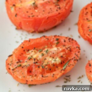 Air Fryer Roasted Tomatoes 10 seasoned and sliced air fried tomato on a white board