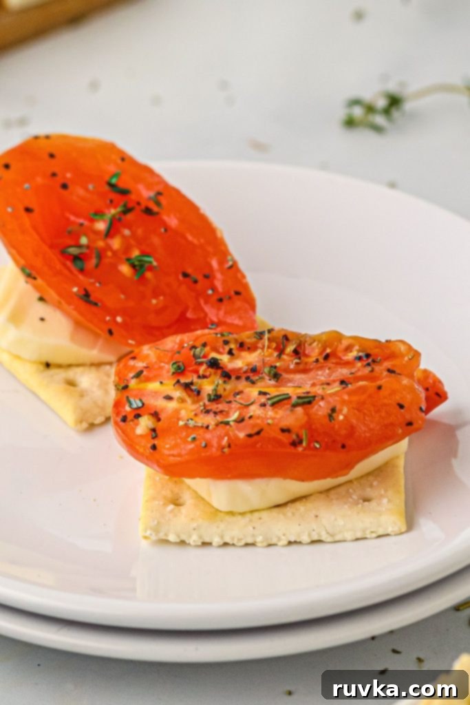Air Fryer Roasted Tomatoes 8 Fried seasoned tomato slice on a cheese and a cracker