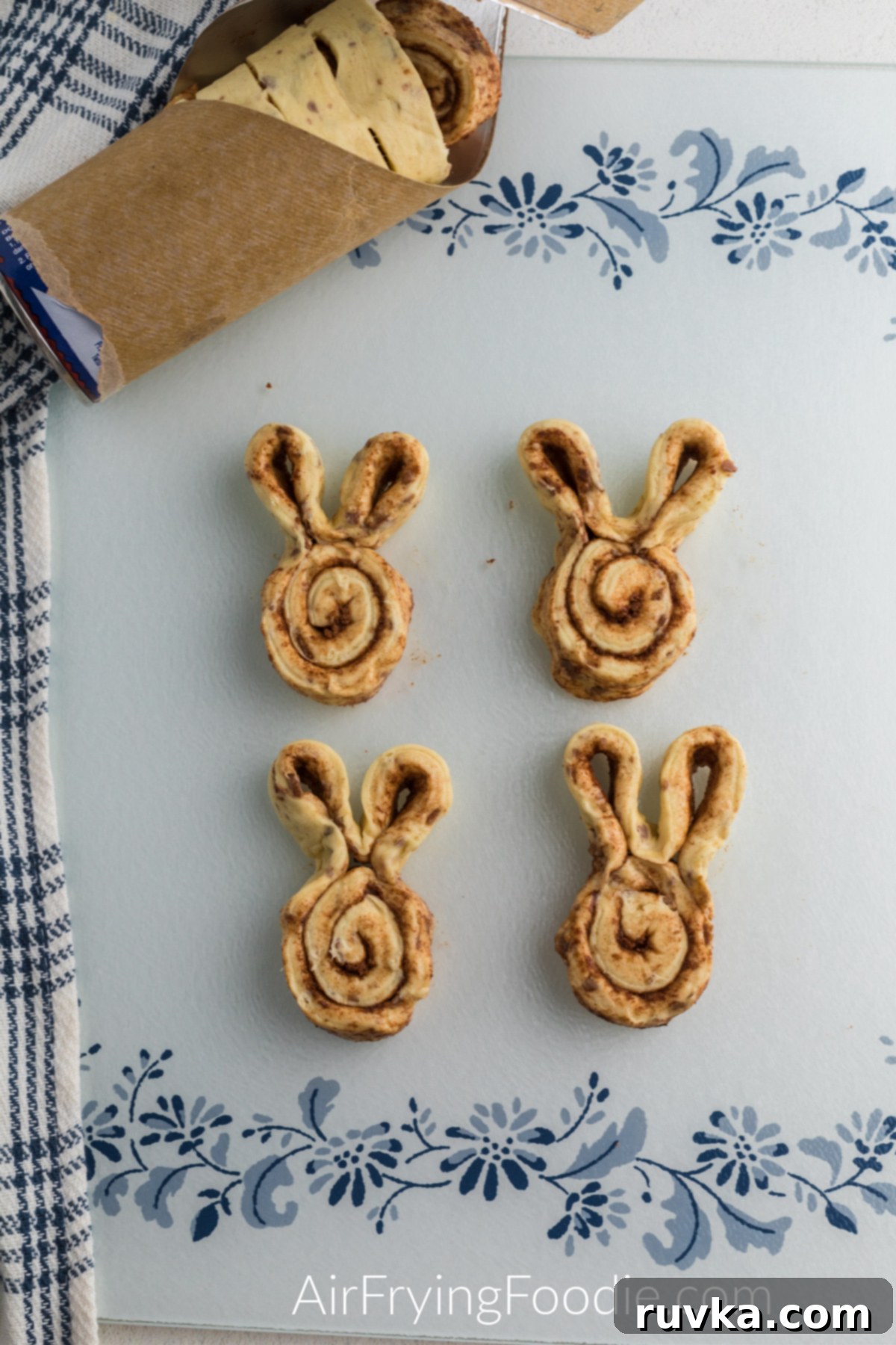 Air Fryer Cinnamon Bunny Delights 4 Several raw cinnamon roll dough pieces expertly shaped into cute bunny forms, with defined ears, awaiting their turn in the air fryer.