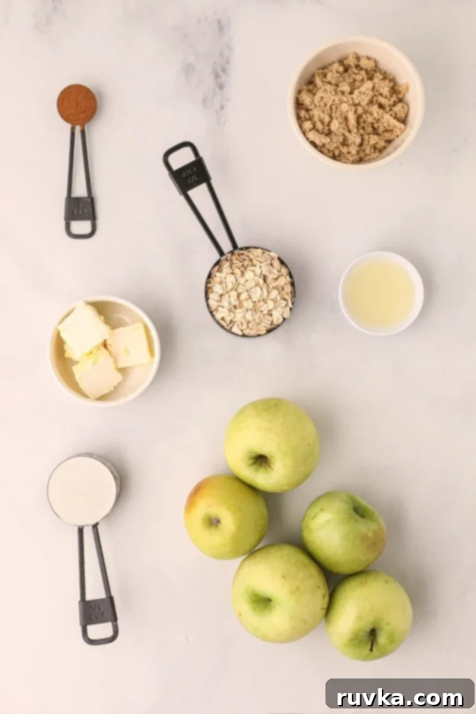 Easy Air Fryer Apple Crisp 3 Ingredients needed to make apple crisp, measured out and on a white marble table