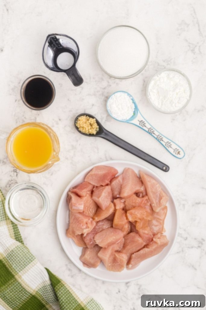 Crispy Air Fryer Sweet & Tangy Chicken 3 Ingredients needed to make sweet and sour chicken on a white marble table.