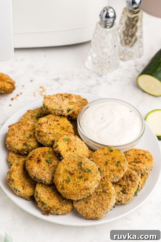 Crispy Air Fryer Zucchini Crisps 2 Crispy breaded zucchini chips after being cooked in the air fryer with ranch dressing dip