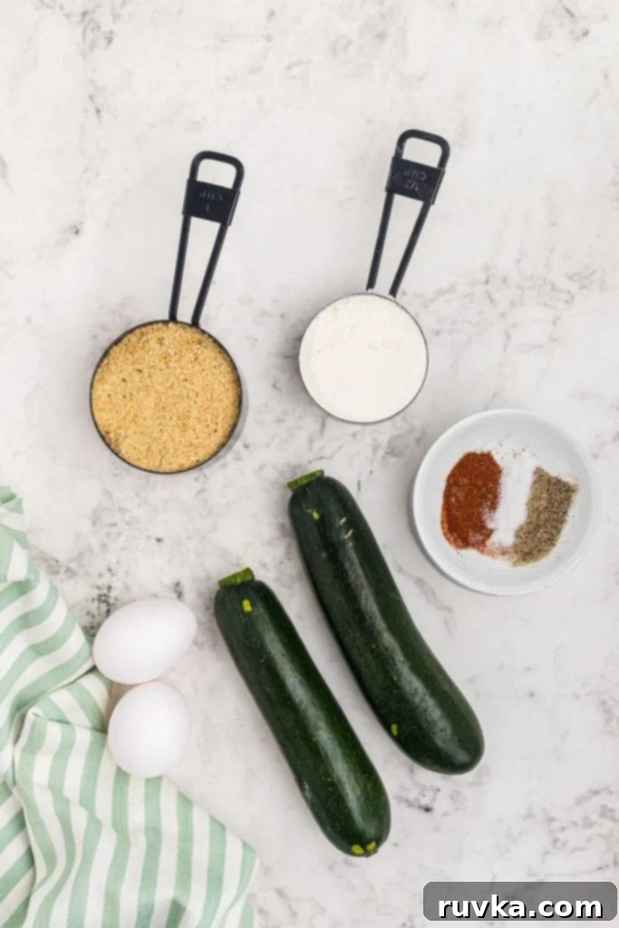 Crispy Air Fryer Zucchini Crisps 3 Ingredients needed to make zucchini chips measured on a white marble table