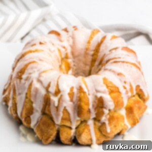 Air-Fried Gooey Cinnamon Pull-Apart 10 Air Fryer Monkey Bread on a white serving plate.