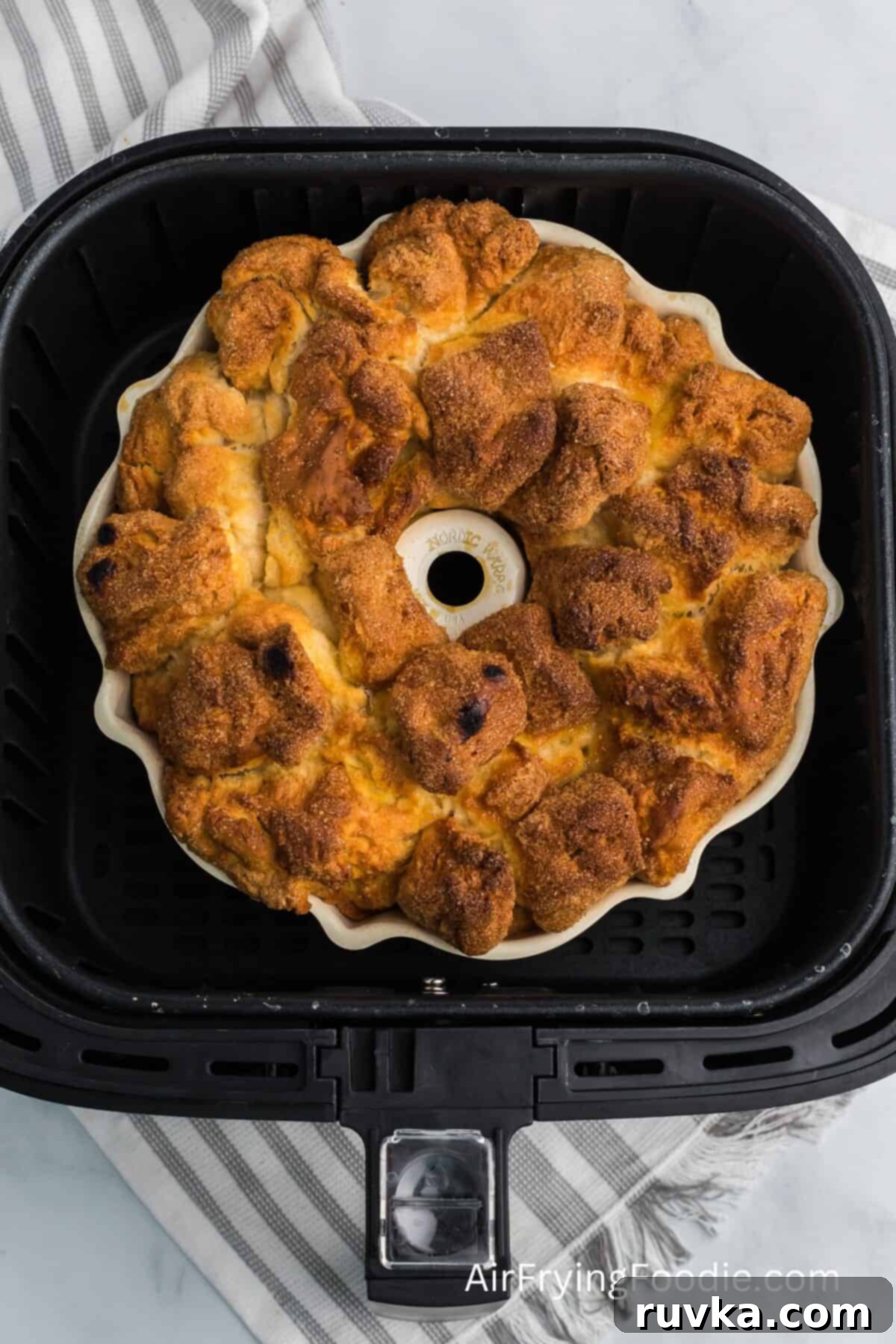 Air-Fried Gooey Cinnamon Pull-Apart 7 monkey bread fully cooked and in the air fryer basket, ready to be removed.