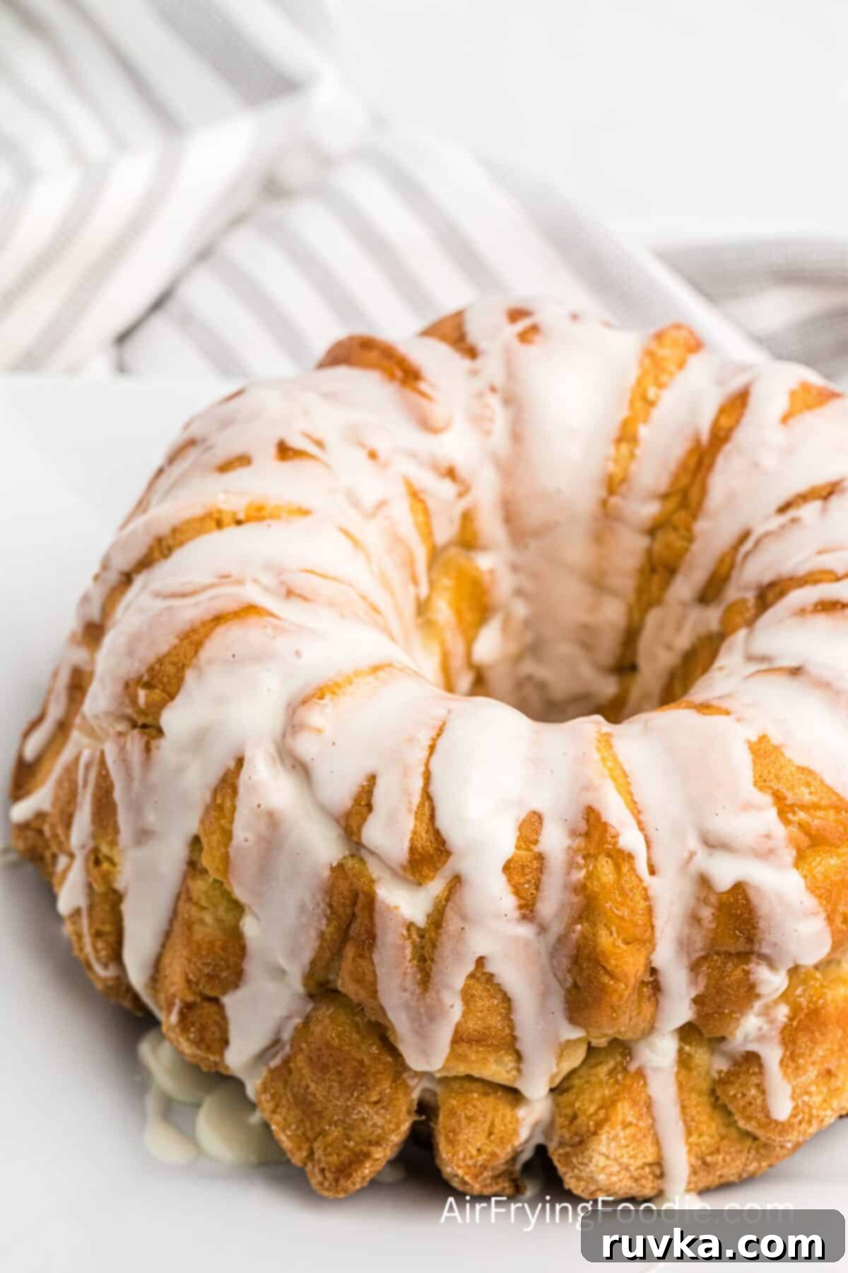 Air-Fried Gooey Cinnamon Pull-Apart 8 Monkey bread drizzled with glaze, ready to eat.