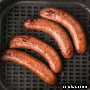 Crispy Air Fryer Italian Sausage 9 Italian Sausage in air fryer basket ready to eat.