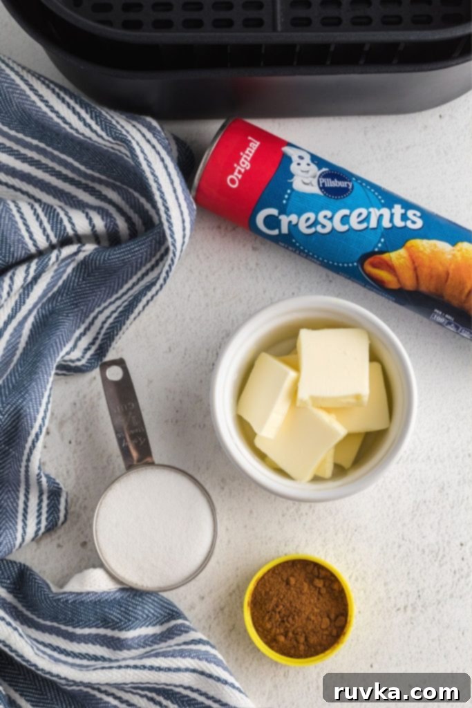 Quick Air Fryer Cinnamon Crescent Rolls 3 Ingredients needed to make cinnamon crescent rolls measured out on a marble table