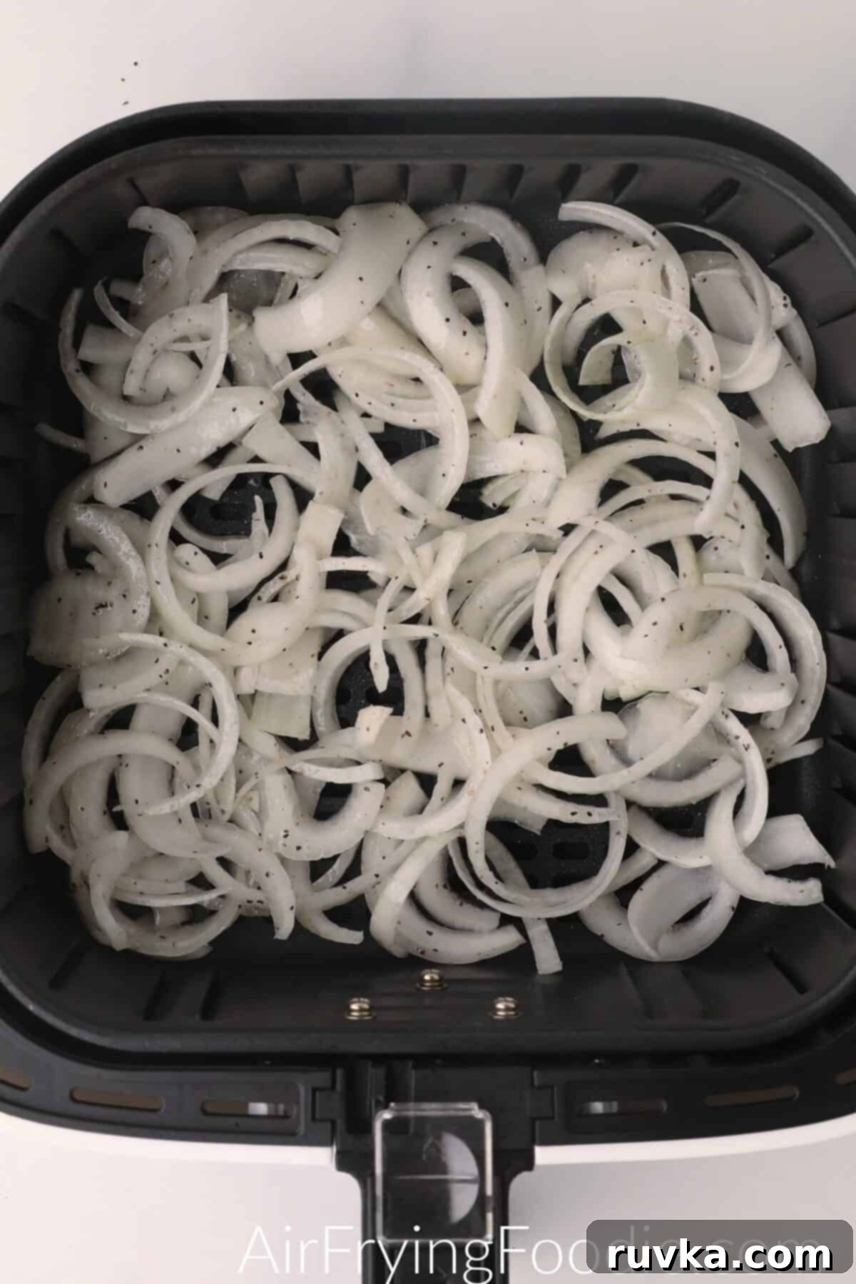 Crispy Air-Fried Onions 6 Onions in the basket of the air fryer, ready to cook.