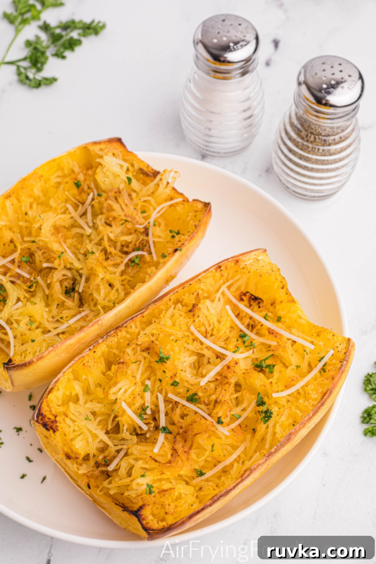 Perfect Air Fryer Spaghetti Squash 12 Spaghetti squash roasted in the air fryer, fluffed, and ready to serve.