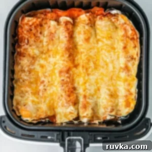 Easy Air Fryer Enchiladas 11 Air fryer enchiladas in the basket, ready to serve.