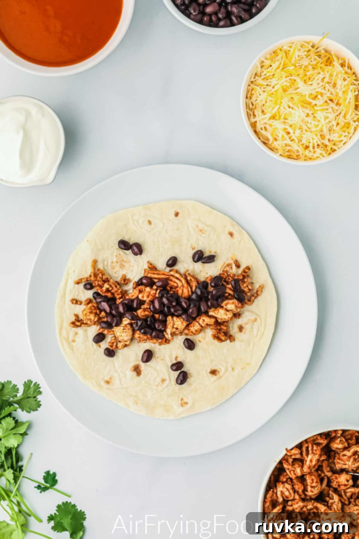 Easy Air Fryer Enchiladas 5 Ground chicken and beans scooped into the tortilla.