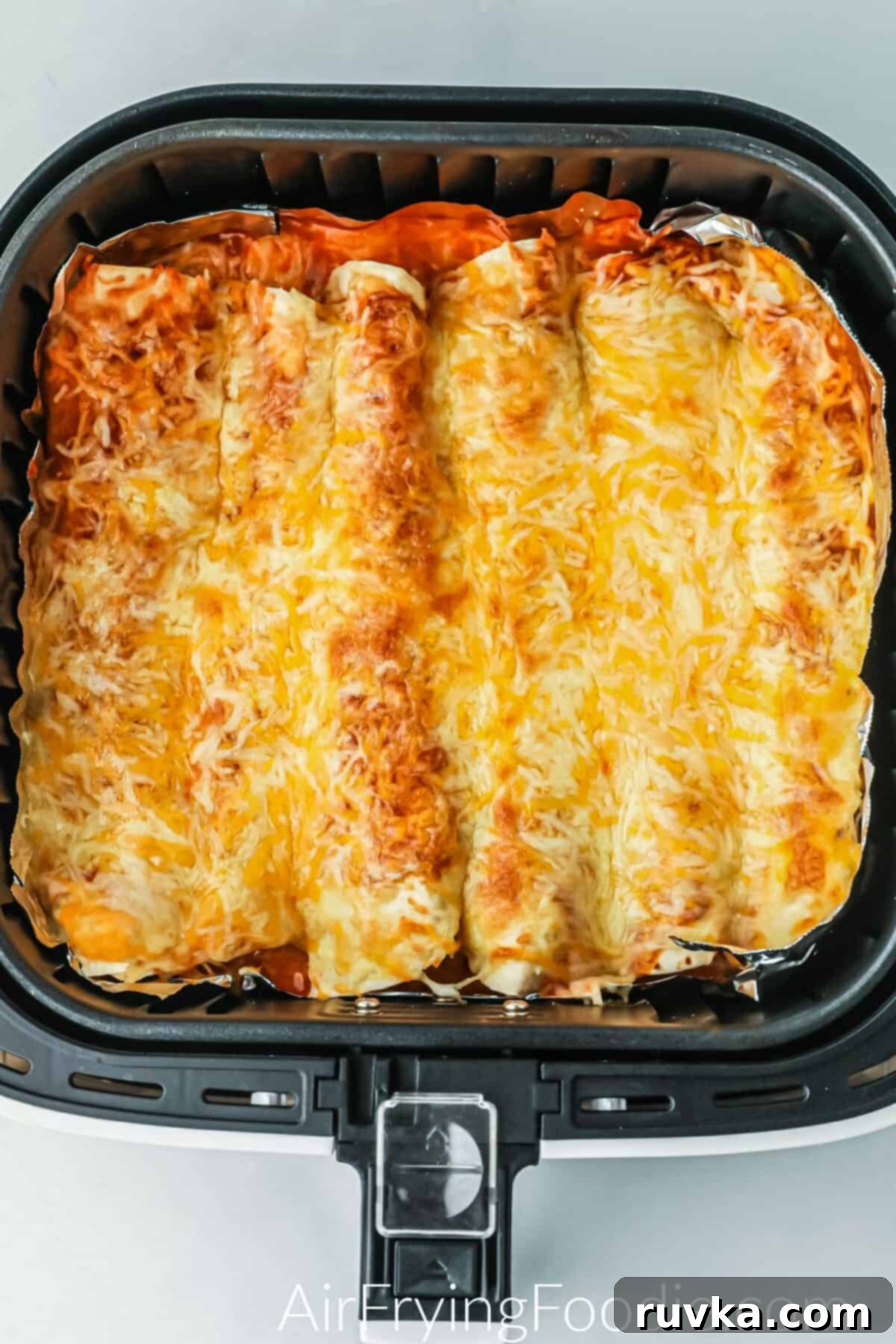 Easy Air Fryer Enchiladas 8 Cheesy enchiladas in the air fryer ready to serve.