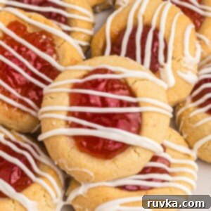 Quick Air Fryer Thumbprint Cookies 11 Golden cookies topped with seedless jam and drizzled with white chocolate