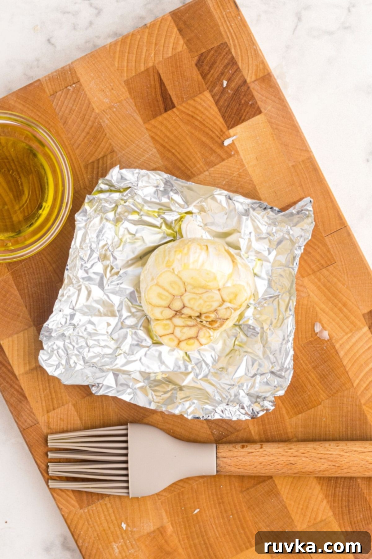Perfect Air Fryer Roasted Garlic 5 Garlic bulb brushed with olive oil on a piece of foil