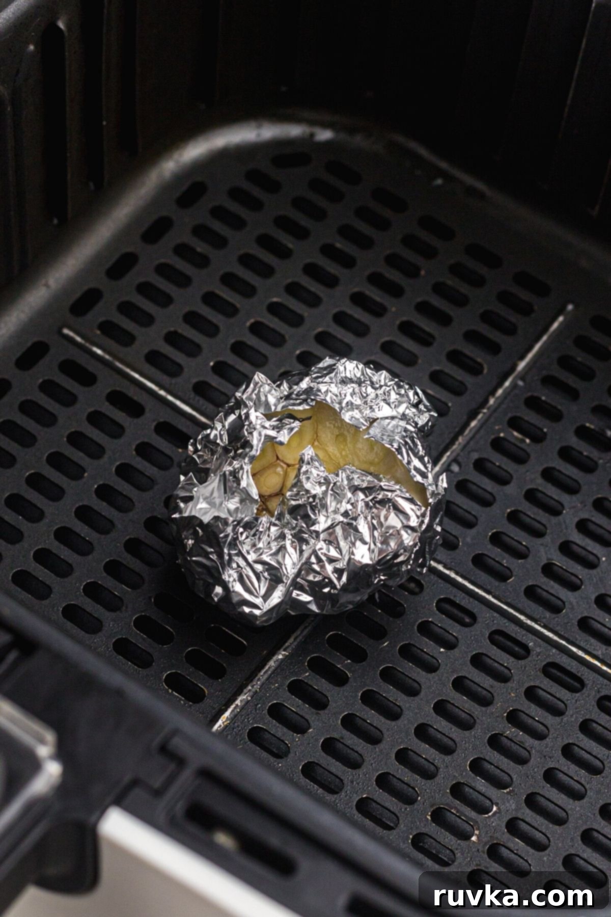Perfect Air Fryer Roasted Garlic 6 Bulb of garlic wrapped in foil in the air fryer basket