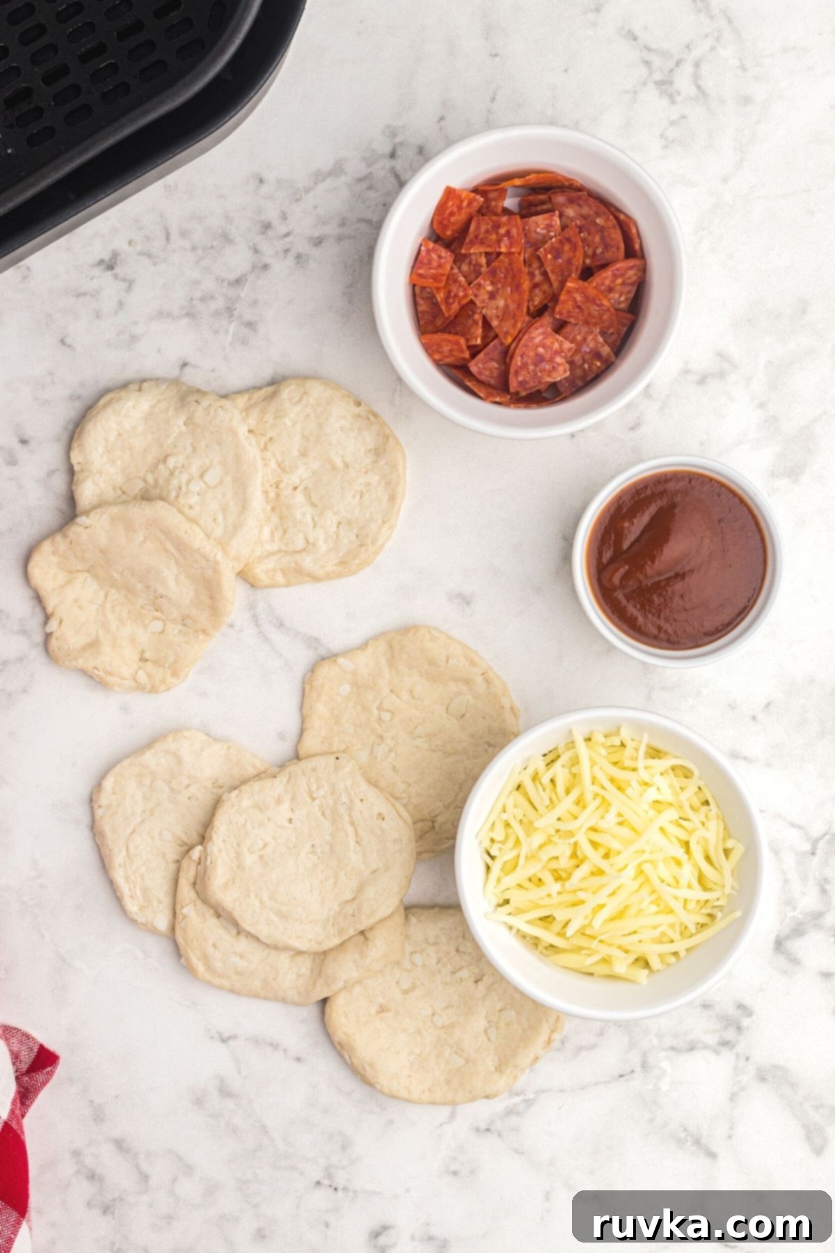 Air Fryer Pizza Poppers 4 Dough divided in half and filling measured out on the table.