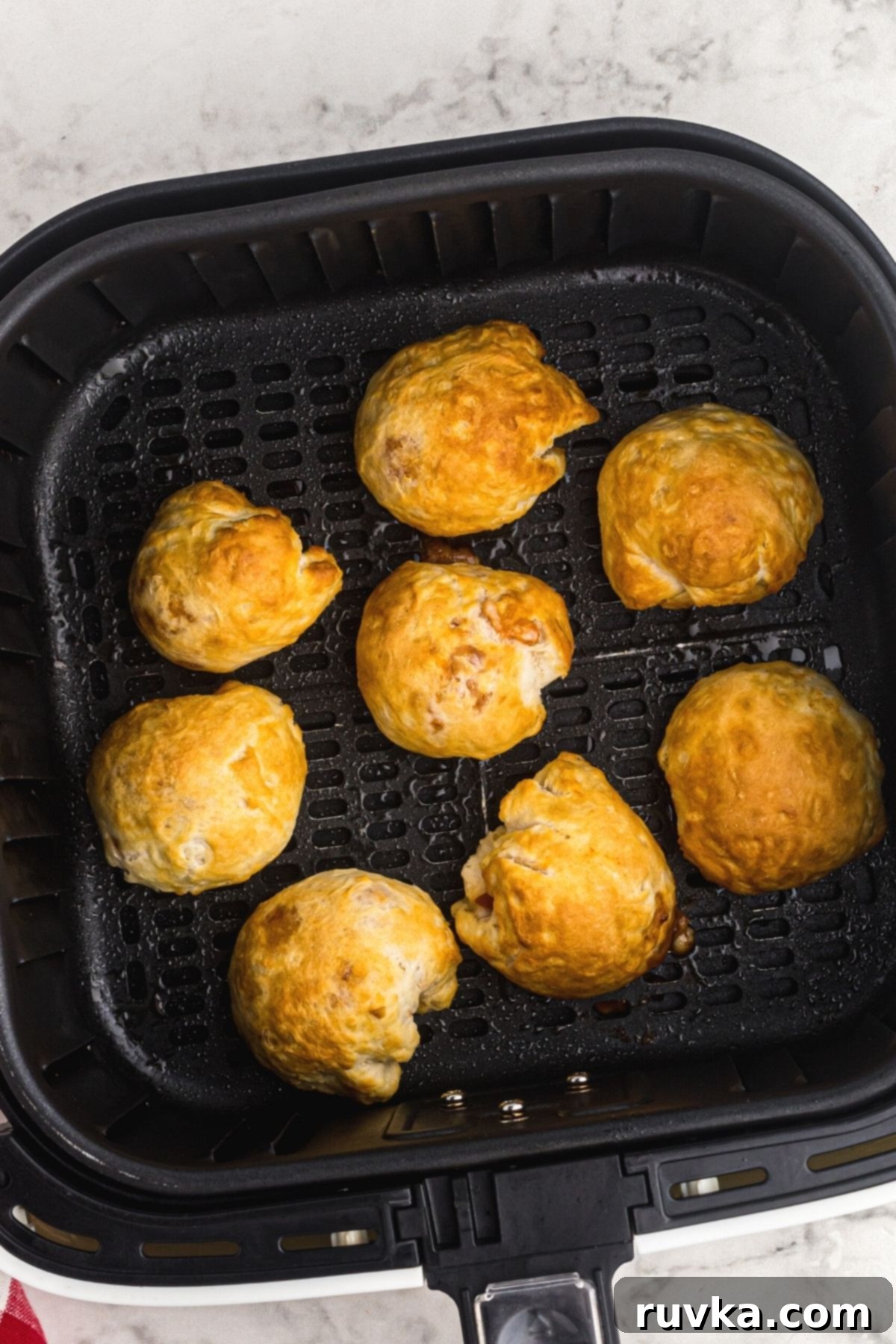 Air Fryer Pizza Poppers 7 Golden biscuits filled with pizza toppings and cooked in the air fryer basket