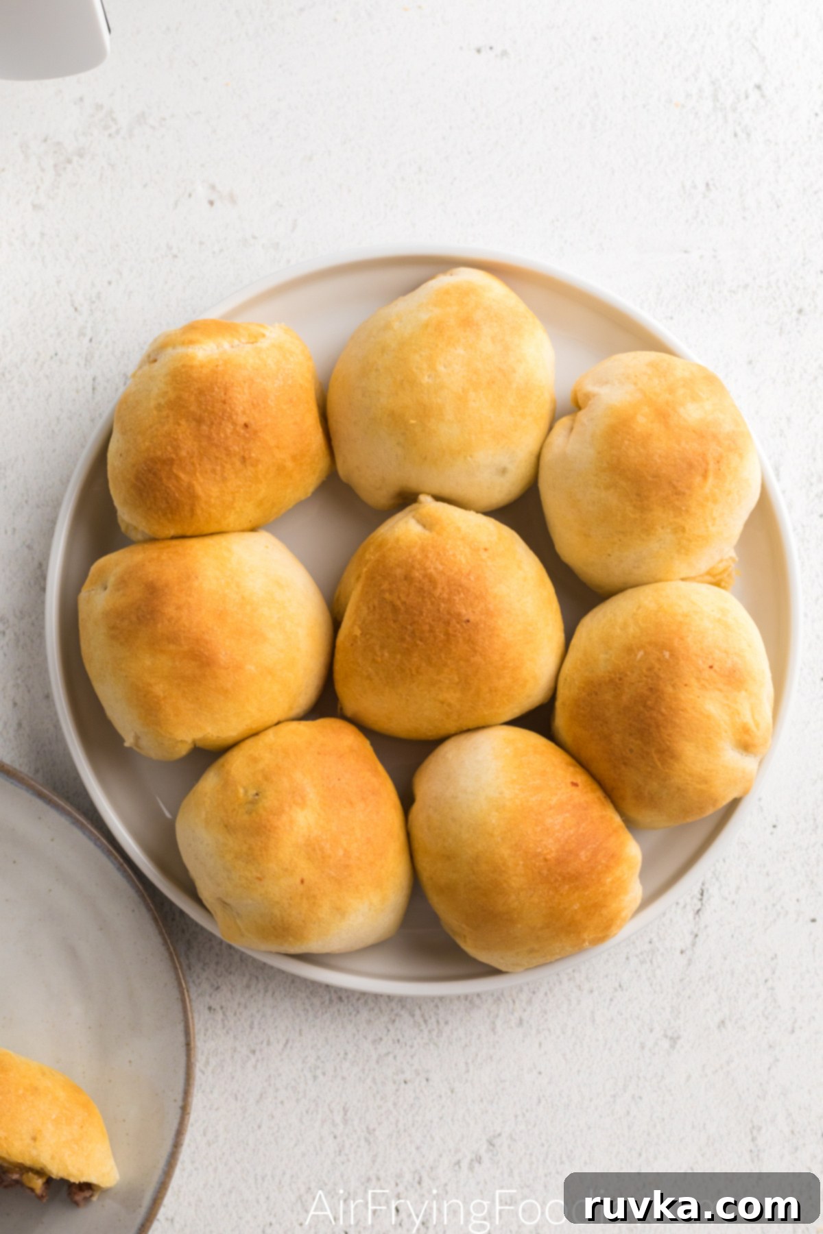 Air Fryer Cheeseburger Poppers 10 Plate full of air fryer cheeseburger bombs.