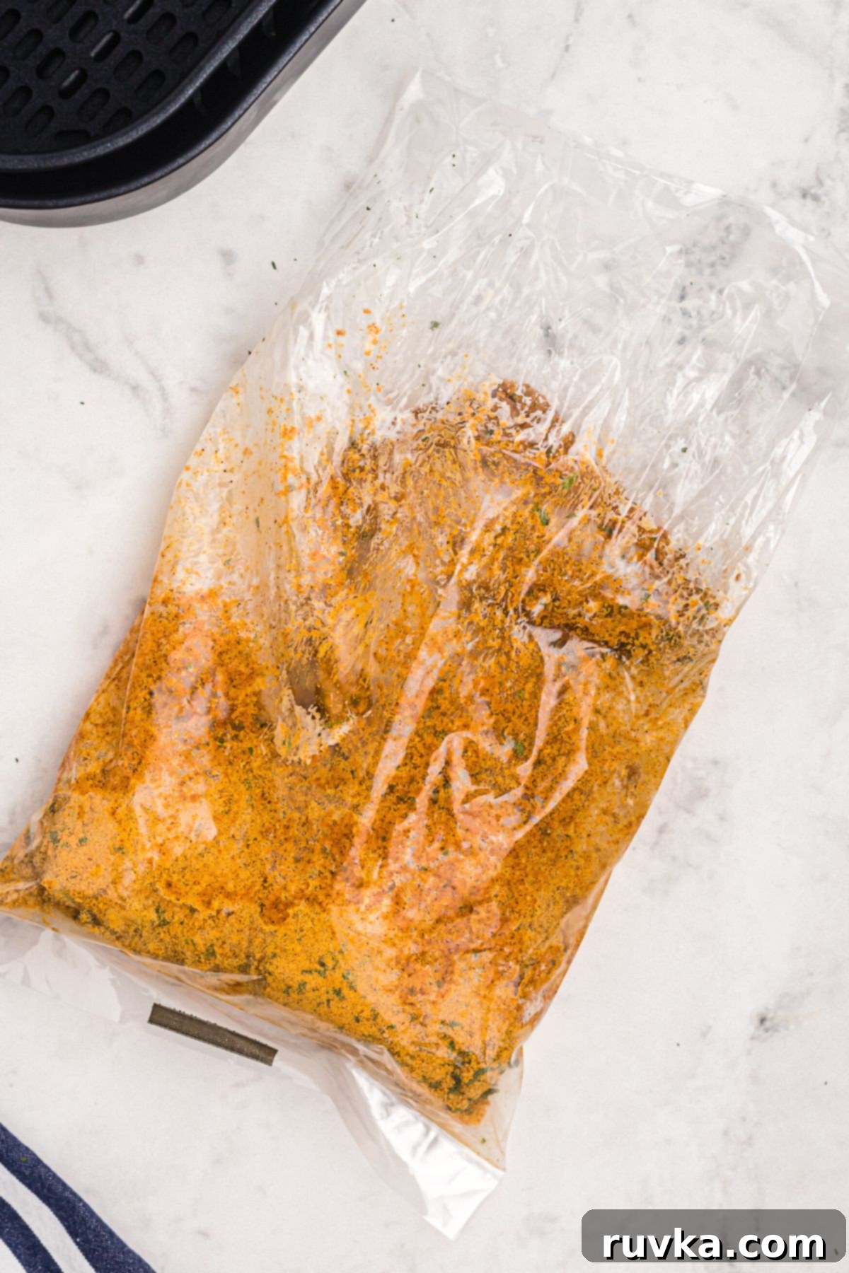 Perfectly Crispy Air Fryer Shake and Bake Chicken 5 Plastic bag with chicken and seasonings shaken to coat chicken