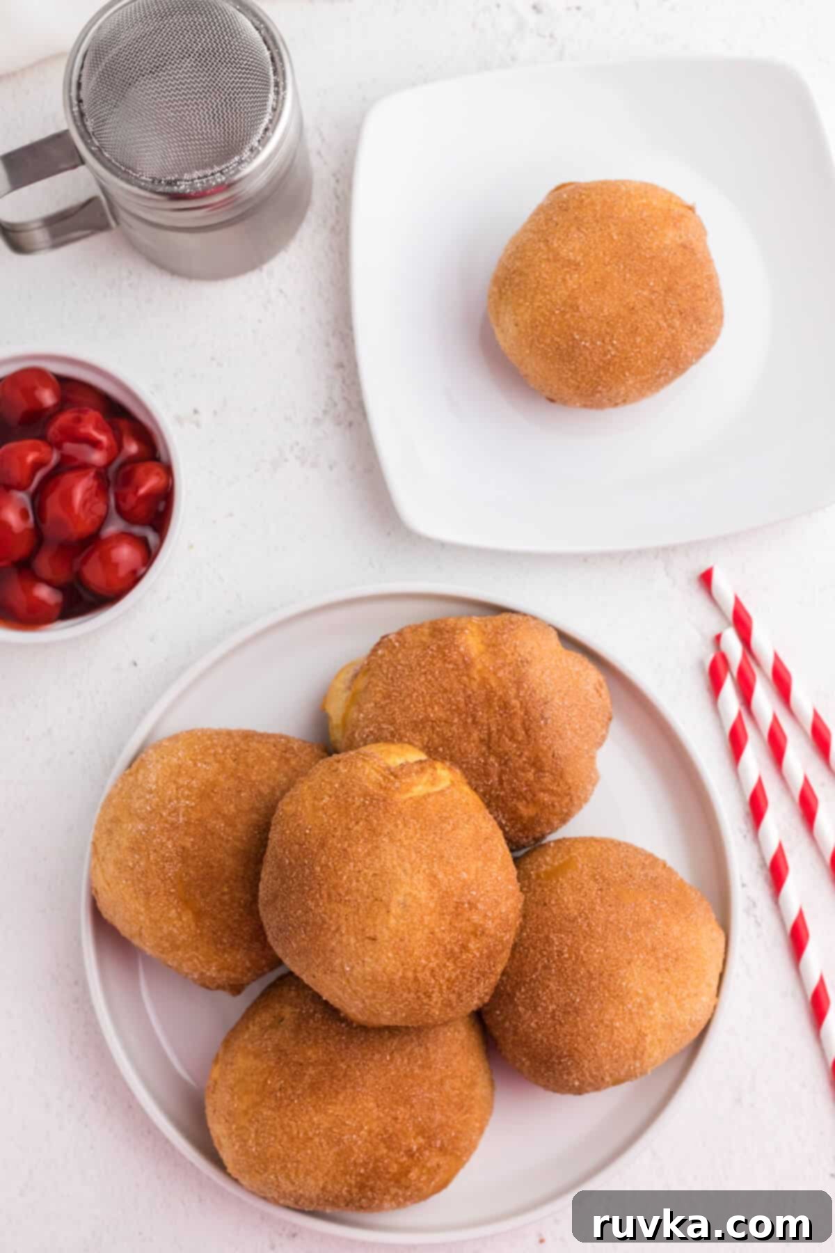 Air Fryer Cherry Pie Bites 9 cherry pie bombs on a plate, ready to serve.