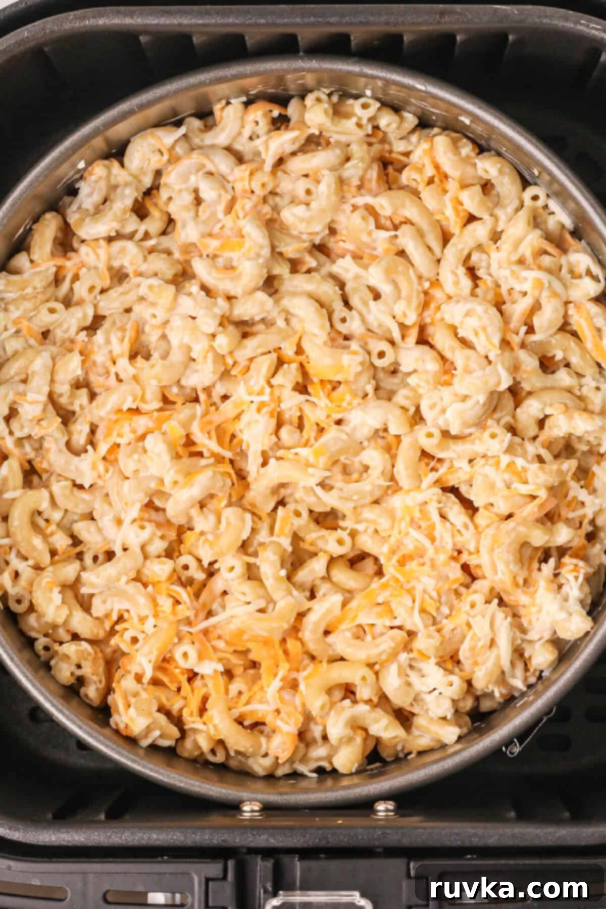 Crispy Air Fryer Mac and Cheese 5 Mac and cheese in a pan in the air fryer basket, ready to be air fried.