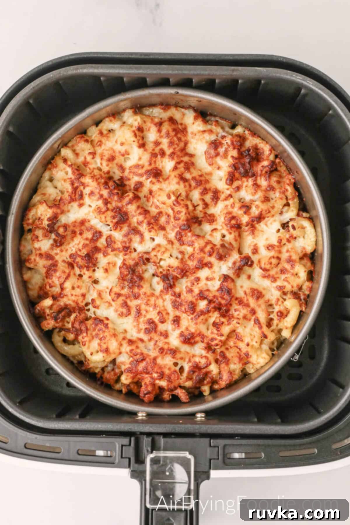 Crispy Air Fryer Mac and Cheese 6 mac and cheese cooked and in the basket of the air fryer.