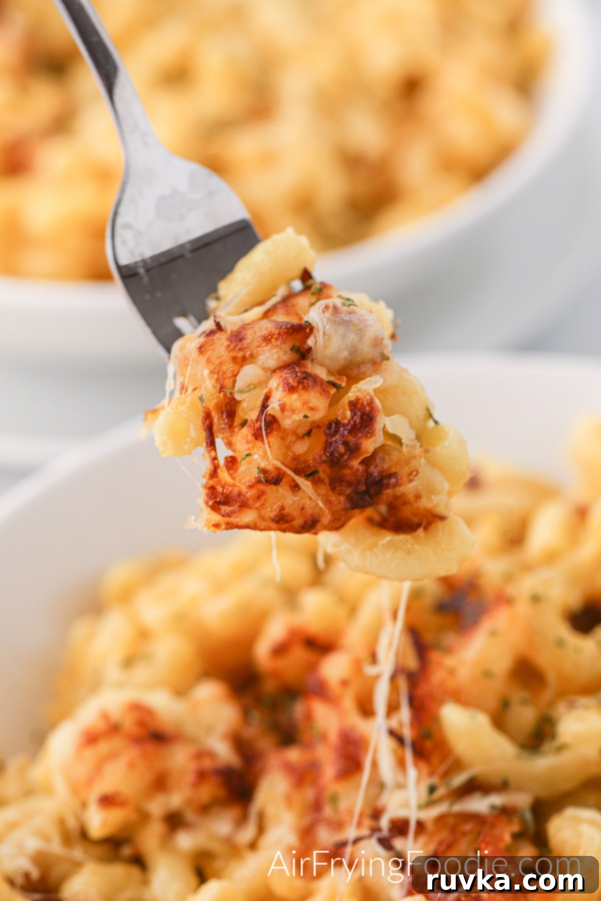 Crispy Air Fryer Mac and Cheese 8 Bite of mac and cheese on a fork, ready to eat.