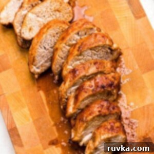 Effortless Easter with Your Air Fryer 11 Juicy brown tenderloin cut into slices on a wooden cutting board.