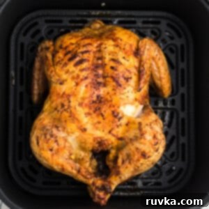 Effortless Easter with Your Air Fryer 15 Air fryer whole chicken fully cooked and in the basket of the air fryer.