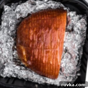 Effortless Easter with Your Air Fryer 3 Fully cooked ham in the air fryer basket, ready to eat.