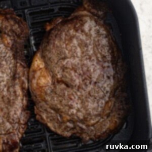 Effortless Easter with Your Air Fryer 7 Juicy ribeye cooked steaks in the air fryer basket.