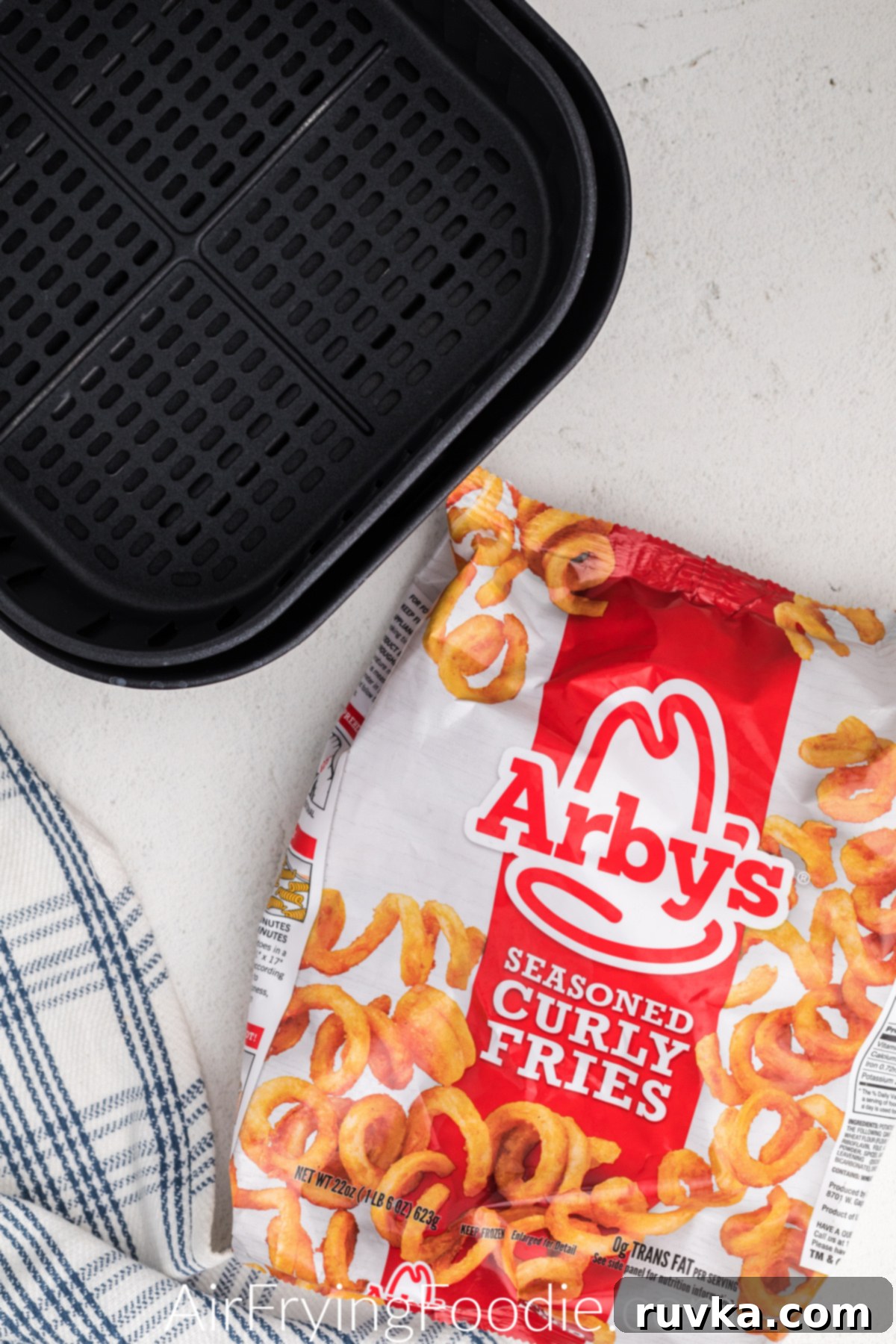 Crispy Air Fryer Frozen Curly Fries 3 Air Fryer Basket and a bag of frozen curly fries from Arby's.